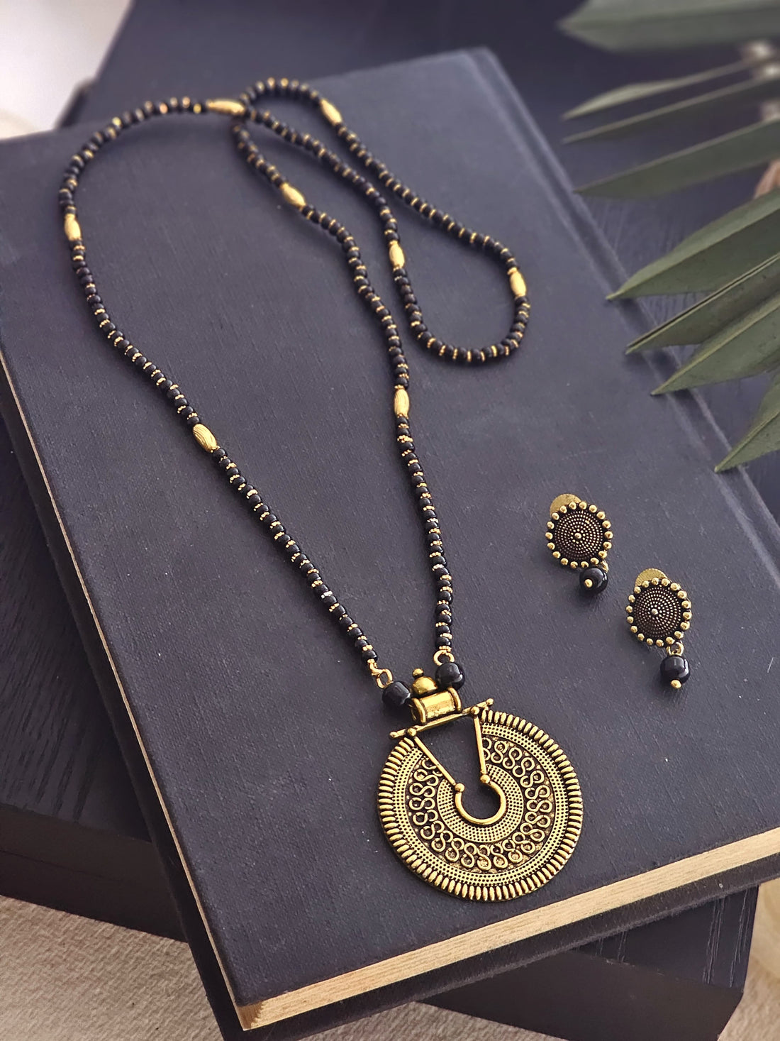 Ravina Gold-Toned Black Beaded Mangalsutra Set with Circular Pendant